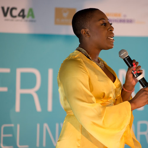 Woman in yellow dress speaking at VC4A event