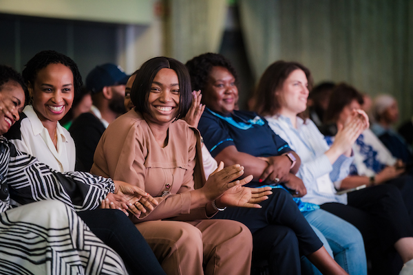 A cross-section of women clapping